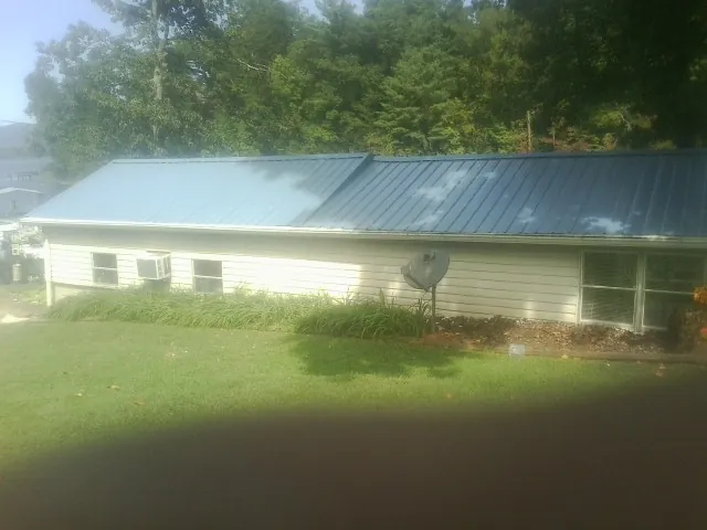 Blue metal roof running the length of a single story home in Belvidere