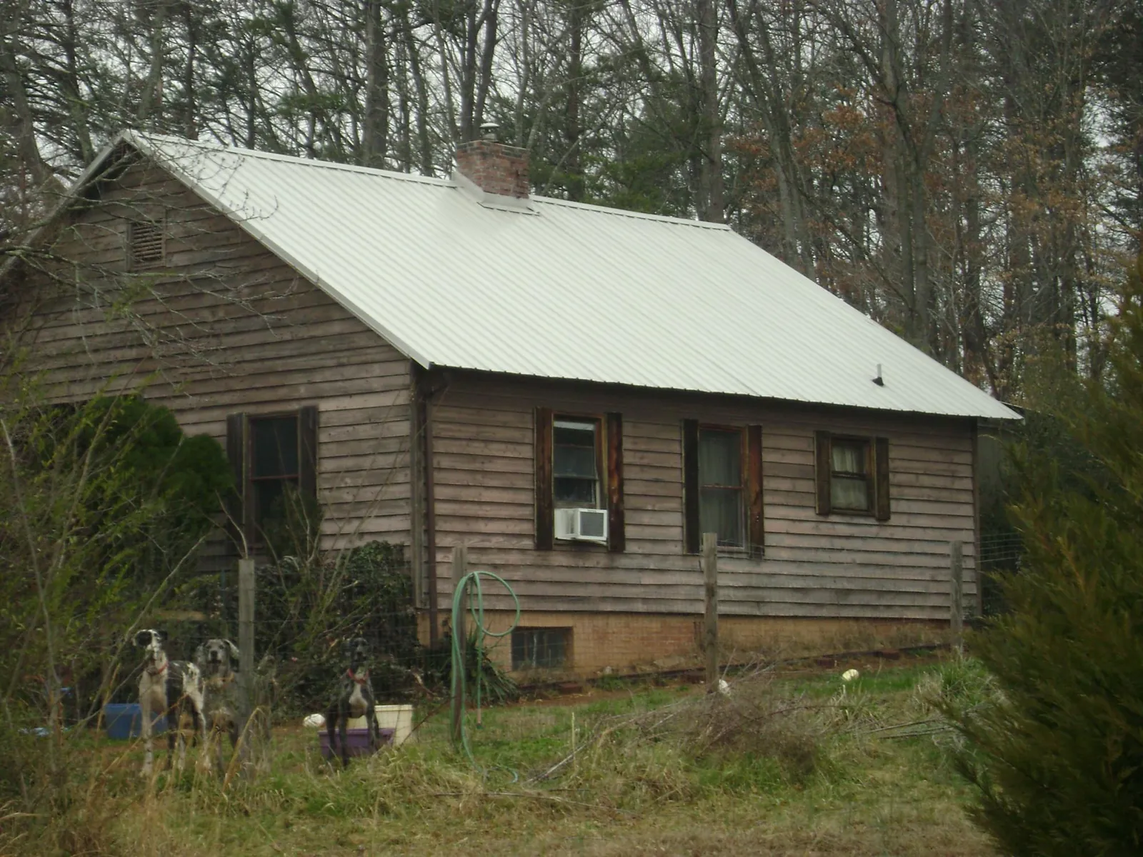 White metal roof on an old wood sided farmhouse, from a Metal Roof Installation job in Belvidere